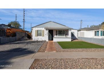 Front yard view of a renovated home with brick driveway at 1614 W Lynwood St, Phoenix, AZ 85007