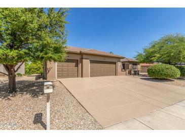 Single-story house with three-car garage and desert landscaping at 17311 N Havasupai Dr, Surprise, AZ 85374