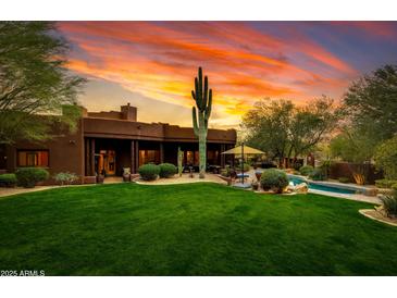 Landscaped backyard with pool and sunset view at 25555 N Wrangler Rd, Scottsdale, AZ 85255