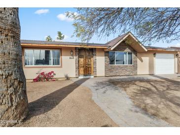 Inviting home exterior with stone accents and a landscaped walkway at 2640 N 49Th Ave, Phoenix, AZ 85035