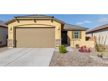 New single-story home with a two-car garage and desert landscaping at 3244 W Cedar Ridge Rd, Phoenix, AZ 85083
