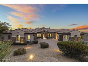 Stunning desert home with a tile roof, arched entryways, and desert landscaping at 36549 N Porta Nuova Rd, Scottsdale, AZ 85262