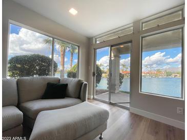 Lakefront living room with comfy seating and fireplace at 10080 E Mountain View Lake Dr # 140, Scottsdale, AZ 85258