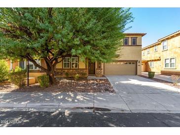 Two-story house with stone accents and a two-car garage at 1059 W Caroline Ln, Tempe, AZ 85284