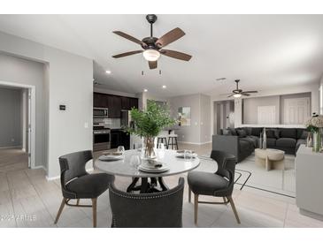 Bright dining area with table and chairs, adjacent to kitchen and living room at 1154 W Lowell Dr, San Tan Valley, AZ 85140