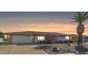 Brick ranch home with a two-car garage and desert landscaping at 12619 N Sun Valley Dr, Sun City, AZ 85351