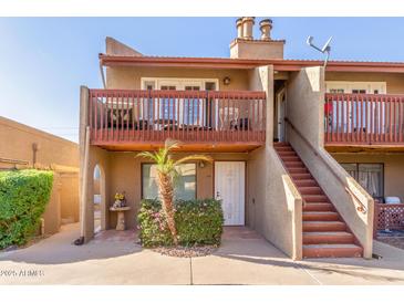 Attractive condo building with a private balcony and stairs at 14203 N 19Th Ave # 1051, Phoenix, AZ 85023