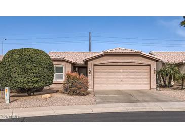 Tan house with a two-car garage and well-maintained landscaping at 1486 E Augusta Ave, Chandler, AZ 85249