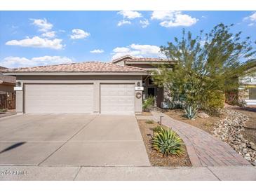 Attractive single-story home with a three-car garage and landscaped front yard at 1618 E Montoya Ln, Phoenix, AZ 85024