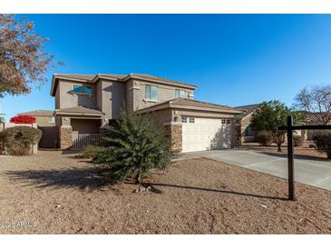 Two-story house with a neutral exterior, attached garage, and landscaping at 17840 W Calavar Rd, Surprise, AZ 85388