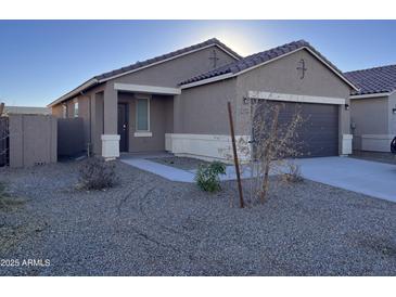 One-story house with brown exterior, attached garage, and desert landscaping at 18227 N Conquistador Dr, Maricopa, AZ 85138