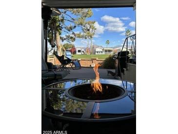 Relaxing backyard view with fire pit and distant mountain views at 2273 S Seminole Dr, Apache Junction, AZ 85119