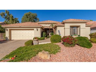 Single-story home with a tan stucco exterior, tile roof, and landscaped front yard at 24826 S Stoney Lake Dr, Sun Lakes, AZ 85248