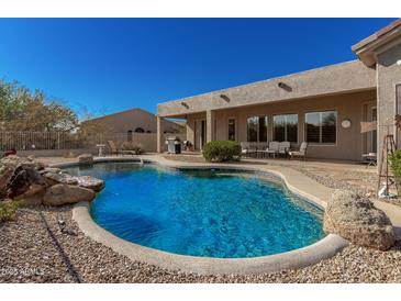 Spacious backyard with a curved pool and patio area at 31847 N 53Rd St, Cave Creek, AZ 85331