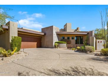 Contemporary home with a large driveway and desert landscaping at 39349 N 107Th Way, Scottsdale, AZ 85262