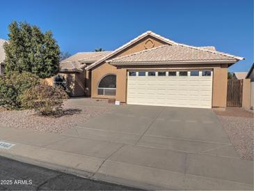 Single-story house with a two-car garage and landscaped front yard at 4302 E Rockledge Rd, Phoenix, AZ 85044