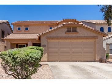 Two-story house with a two-car garage and well-manicured landscaping at 43864 W Elizabeth Ave, Maricopa, AZ 85138