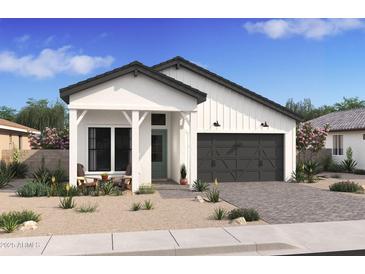 One-story home with white exterior, dark gray garage door, and landscaping at 4444 N 203Rd Dr, Buckeye, AZ 85396