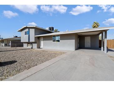 Gray house with a carport and gravel driveway at 4902 W Cypress St, Phoenix, AZ 85035