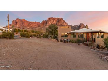 Desert landscape home with mountain views, welcoming entryway, and charming patio at 6013 E Lost Dutchman Blvd, Apache Junction, AZ 85119