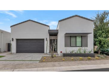 Modern home with a two-car garage and desert landscaping at 6147 E Alta Hacienda Dr, Scottsdale, AZ 85251