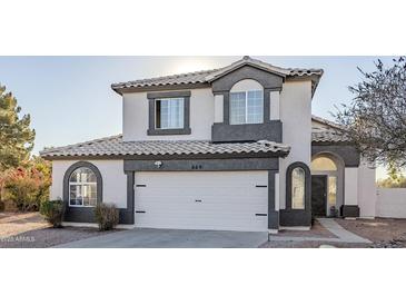 Two-story house with gray and white exterior, two-car garage, and landscaping at 669 S Saddle St, Gilbert, AZ 85233