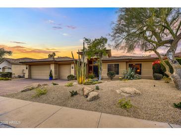 Beautiful desert landscape surrounds this single-story home with a three-car garage at 9690 N 117Th Way, Scottsdale, AZ 85259