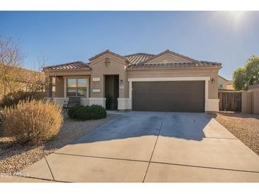 Single-story home with a two-car garage and desert landscaping at 11271 E Sunflower Ct, Florence, AZ 85132