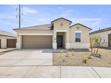 New single-story home with a two-car garage and desert landscaping at 1615 S 239Th Dr, Buckeye, AZ 85326