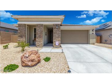 One-story home with stone accents and a two-car garage at 18956 W Laurel Ln, Surprise, AZ 85388