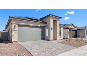 Charming single-story home with a two car garage, stone accents, paver driveway and low maintenance landscaping at 20316 W Turney Ave, Buckeye, AZ 85396