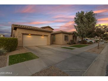 Single-story home with a two-car garage and landscaped front yard at 22910 E Sonoqui Blvd, Queen Creek, AZ 85142