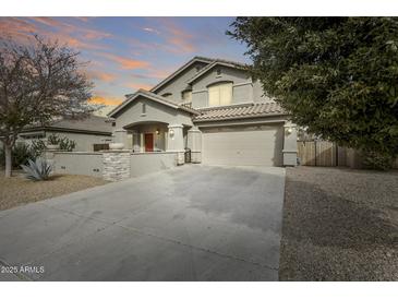 Two-story home with a large driveway and landscaped yard at 44192 W Canyon Creek Dr, Maricopa, AZ 85139