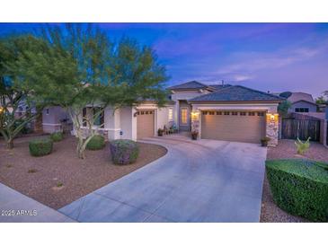 Two-story house with a two-car garage and landscaped front yard at 13813 W Monterey Way, Avondale, AZ 85392