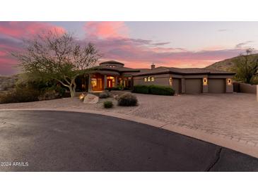 Stunning desert home with a circular driveway and desert landscaping at 14216 S Canyon Dr, Phoenix, AZ 85048