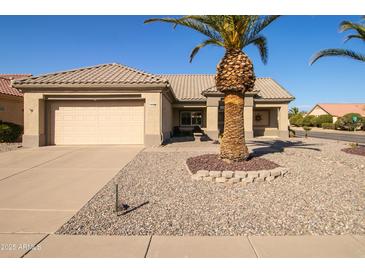 Single-story home with attached garage and desert landscaping at 16148 W Sentinel Dr, Sun City West, AZ 85375