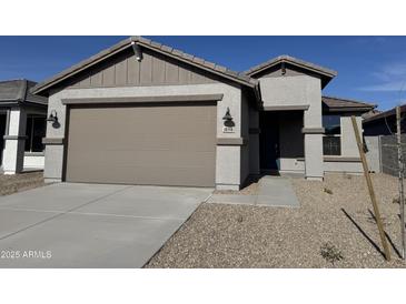 Modern home exterior with two-car garage and landscaping at 18358 W Poston Dr, Surprise, AZ 85387