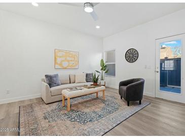 Bright living room with comfy seating, large windows, and stylish decor at 18815 N 34Th Ave # 4, Phoenix, AZ 85027