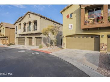 Two-story townhome with attached garage and landscaped front at 2250 E Deer Valley Rd # 48, Phoenix, AZ 85024