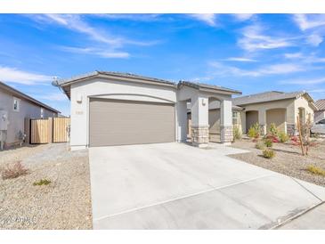 New construction home exterior with a two-car garage and landscaped front yard at 23120 E Twilight Dr, Queen Creek, AZ 85142