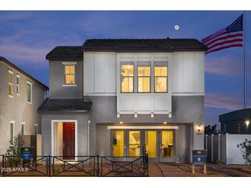 Two-story home with gray siding, red door, and a well-manicured lawn at 2444 W Rowel Rd, Phoenix, AZ 85085