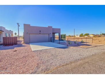 Single-story home with attached garage and gravel driveway at 3015 W Paraiso Dr, Eloy, AZ 85131