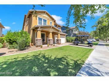 Two-story house with a landscaped yard and golf cart at 3548 E Mesquite St, Gilbert, AZ 85296