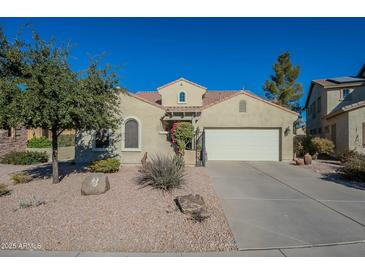 Single-story house with a two-car garage and desert landscaping at 36080 W Merced St, Maricopa, AZ 85138