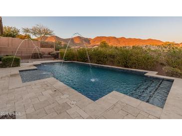 Inviting pool with water features and mountain views at 42405 N Anthem Creek Dr, Anthem, AZ 85086