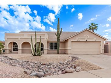 Single-story home with desert landscaping and two-car garage at 4963 E Hobart St, Mesa, AZ 85205