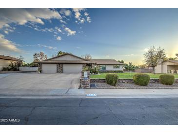 Beautiful 3-car garage home with landscaped lawn and stone accents at 5133 W Monte Cristo Ave, Glendale, AZ 85306