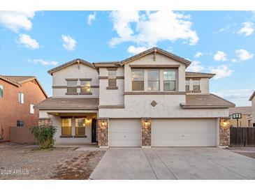 Two-story house with three car garage and stone accents at 687 E Cleveland Ct, San Tan Valley, AZ 85140