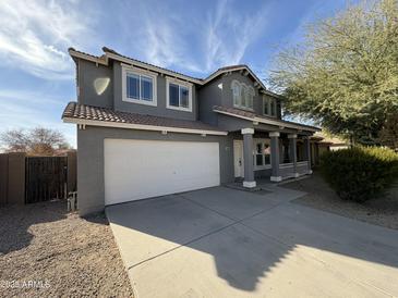 Two-story house with gray exterior, white garage door, and landscaping at 11658 N 153Rd Ave, Surprise, AZ 85379