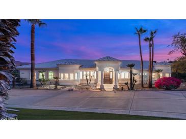 Stunning desert home with palm trees and a long driveway at 16439 E Nicklaus Dr, Fountain Hills, AZ 85268